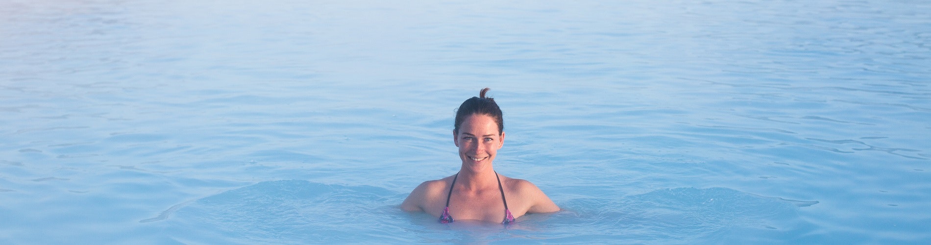 Woman bathing in a hot spring in Iceland