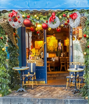 Charming Christmas decorations on a coffee shop in Paris, France