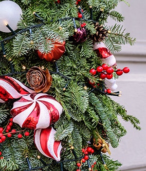 A Danish Billund Christmas tree decorated with red and white holiday decorations